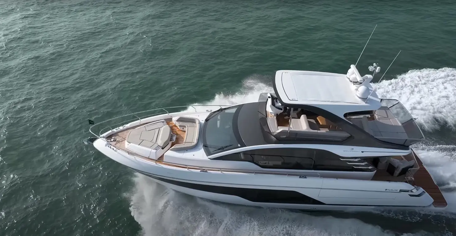 Luxury motor yacht cruising through the water, showcasing a sleek design and spacious deck for relaxation.